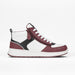 High-top sneaker with maroon, black, and white color scheme on a light gray background
